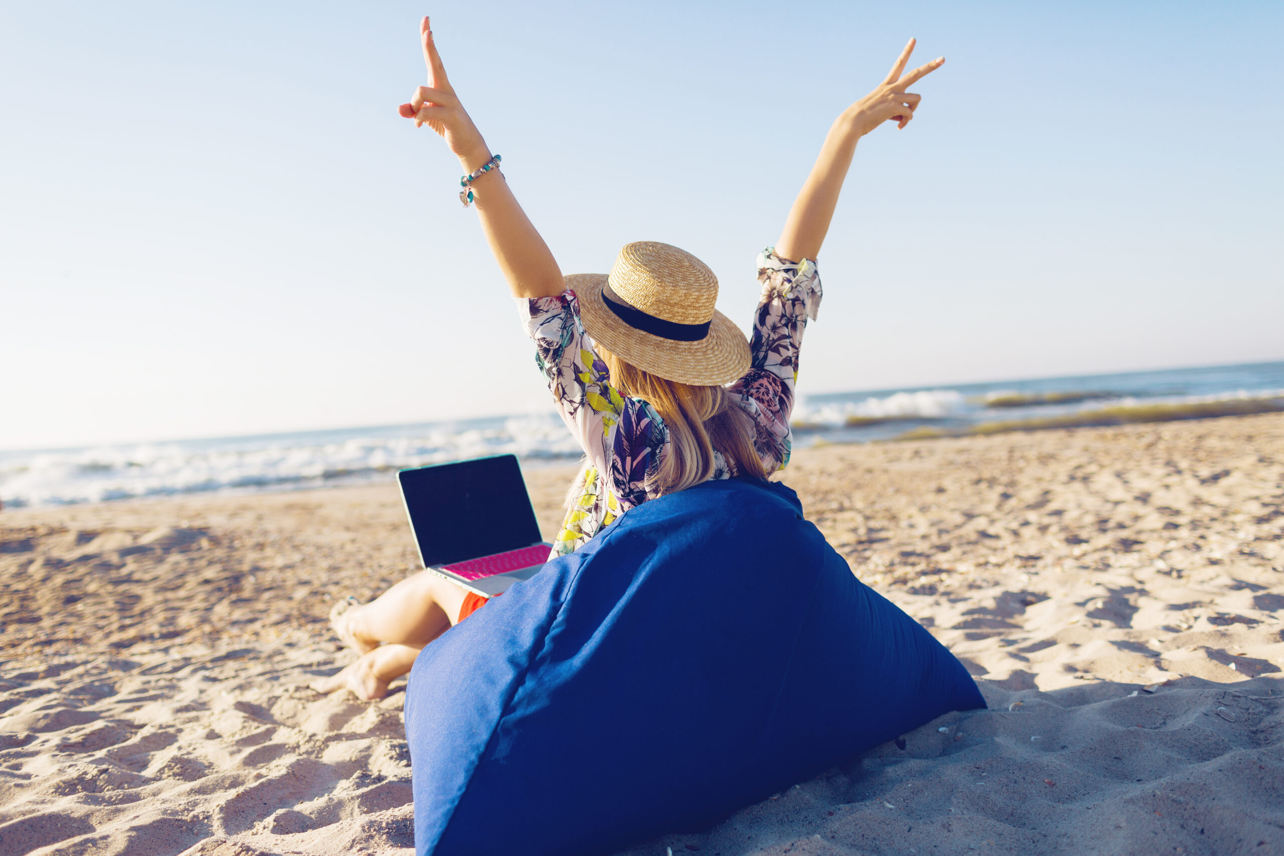 woman with a laptop on a beach